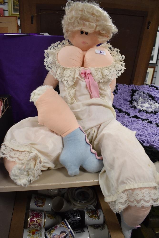 A comical rag doll needing some restoration.