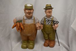Two novelty pottery ornaments of gardeners, both measuring 40cm tall