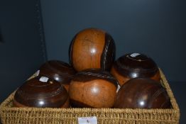 A group of six antique wooden lawn bowls with simple turned decoration