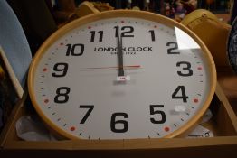 A retro plywood cased Boho London Clock, having a 53cm diameter, and including its box