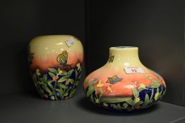 Two Old Tupton Ware tube lined vases, decorated with butterflies and flowers, the largest