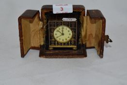 An early 20th Century miniature Zenith alarm timepiece, the enamelled case enclosing a Swiss