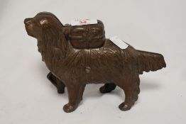 An early 20th Century cast metal novelty money bank, in the form of a St Bernard dog, measuring 18cm