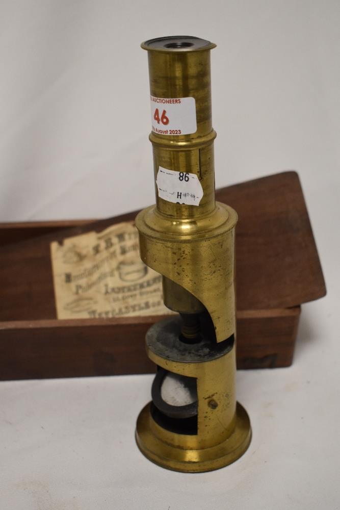 A Victorian brass field microscope, 22cm tall, with case