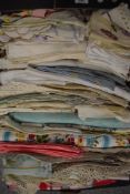 A box of vintage and antique table linen, including embroidered, coloured and lace edged items.