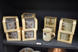 An assorted collection of boxed Denby Coloroll stoneware mugs and egg cups in the Daybreak and