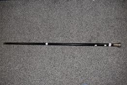 A Victorian ebonised walking cane, with silver coloured (indistinctly hallmarked) rounded top,