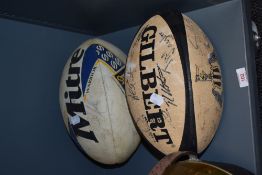 Two vintage rugby balls, including a Newcastle Rugby Club version, both having signatures
