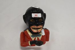 A 20th Century hand painted mechanical money bank, in the form of a Jolly man, measuring 15cm tall