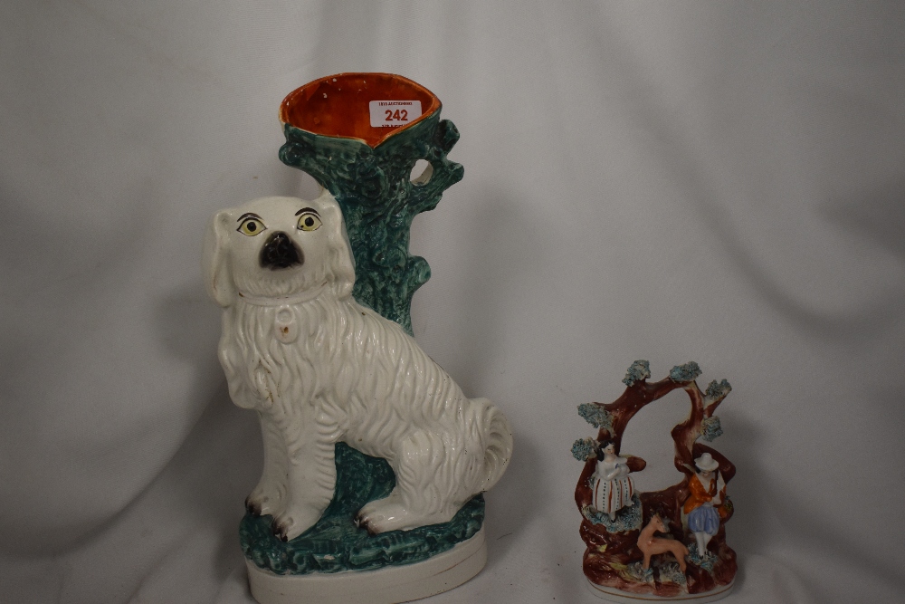 A 19th Century Staffordshire pottery spaniel vase, 35cm tall, and another figural ornament of same