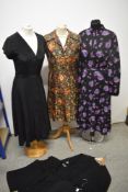 A mixed lot of 1960s and 1970s clothing, to include; three blouses, a floral pleated dress, a floral