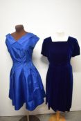 A 1950s heavy midnight blue velvet pleated dress and a 1950s blue party dress.