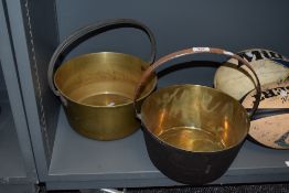 A 19th Century brass preserve pan and another, the largest measuring 32cm tall