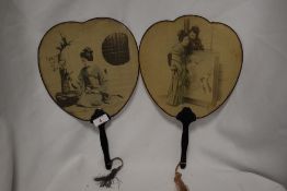 A pair of late 19th Century Japanese hand held silk fans, with ebonised handles, measuring 34cm