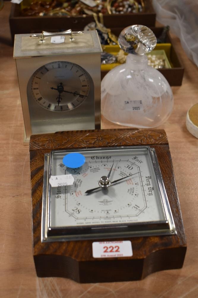 An early 20th Century oak carved Smiths barometer, an Estyma Quartz mantel clock, and a mottled