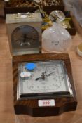 An early 20th Century oak carved Smiths barometer, an Estyma Quartz mantel clock, and a mottled