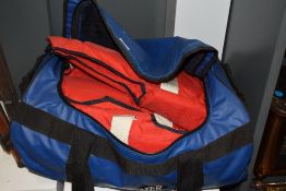 A blue holdall containing five Musto & Hyde life jackets, plus four assorted life jackets in a