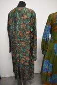 A 1950s cotton two piece outfit in autumnal tones, a 1950s green and brown day dress and a 1960s