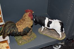 A Sherratt & Simpson resin Holstein bull ornament, 57329, measuring 27cm long, and a Leonardo