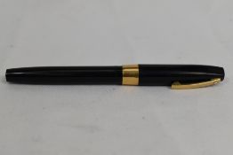 A Sheaffer Imperial cartridge/converter fountain pen in black having broad band to cap and white