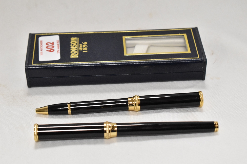 A boxed Ronson fountain pen and rollerball pen in black with gold trim