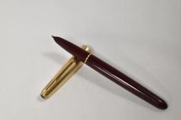 A Parker 51 fountain pen in burgundy with rolled gold cap. Fair condition some age related rubbing