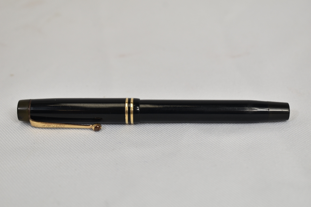 A Parker Duofold Streamlined button fill fountain pen in black with two bands to the cap and