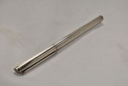 A Dunhills Slimline cartridge fountain pen in white metal having Dunhill 14K nib. In very good