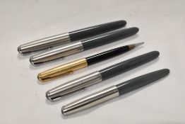 Four Parker 51 aerofill fountain pens and a Parker 51 propelling pencil. Pens all in grey with