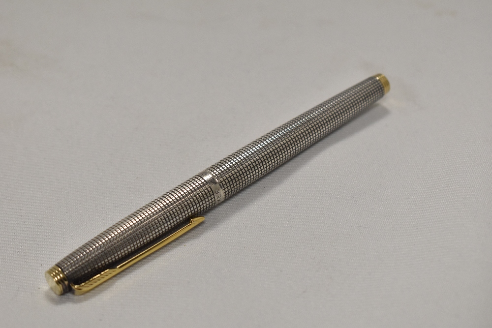 A Parker 75 Ciselle cartridge fountain pen in sterling silver with gold trim having Parker 14k