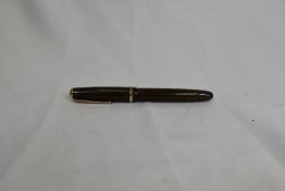 A Parker Duofold pump fill fountain pen in green with decorative band to cap having Parker 30 nib.