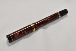 A Parker Duofold Centennial converter fill fountain pen in red swirl with one broad and one narrow