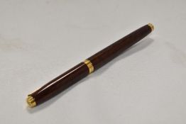 A Parker 75 Thuya cartridge fountain pen, with broad band to cap collar having Parker 14k nib. In