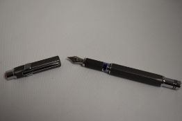 A TWSBI Precision twist fill fountain pen in case in hexagonal grey with silver coloured trim. In