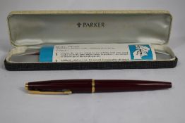 A boxed Parker 45 fountain pen in Maroon. In good condition