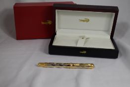 A Crocodile 618 New York rollerball. This gold and silver pen with swirled pinstripe design and
