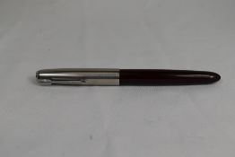 A Parker 51 aeromatic fill fountain pen in dark burgundy with lustiloy cap. Approx 13.8cm in very
