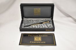 A Pelikan Toledo 700 Piston fill fountain pen with box. Body with decorative band in gold-plated