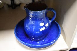 An earthenware jug and bowl set, having a blue and brown glaze, 31cm overall