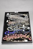 A tray of assorted decorative costume jewellery necklaces, to include strings of Wedding Cake beads,