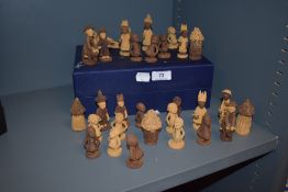 A selection of carved softwood African novelty chess pieces.