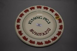 An Emma Bridgwater plate, having pig border over the words Kissing pigs.