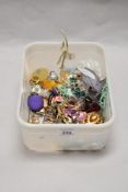 A box of miscellaneous costume jewellery, to include a large gold coloured rose brooch, a dream
