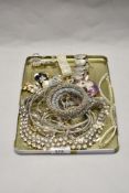 A tray of decorative diamante jewellery, including necklaces and bracelets, a gold coloured