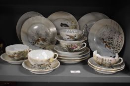 A selection of Japanese eggshell cups, saucers and plates, having delicate hand painted scenes of