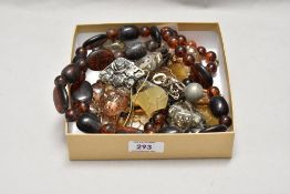 A collection of strings of decorative beads, including amber coloured beads