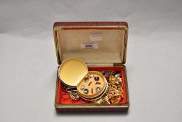 A travelling jewellery case, housing a collection of costume jewellery and vintage plated collar