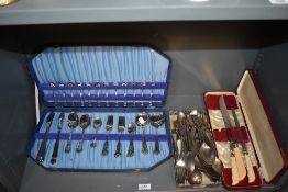 An assortment of loose cutlery and a partial canteen of plated cutlery.