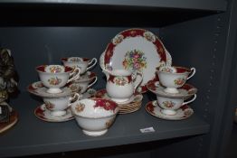 A collection of Shelley tableware, including cups and saucers, cream jug, sugar basin and cake