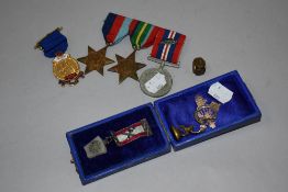 An assortment of medals and wax sealing stamps, including WW2 interest.